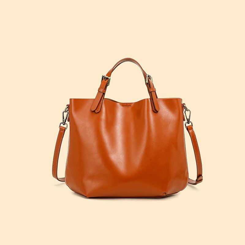 Brown leather handbag on a beige background