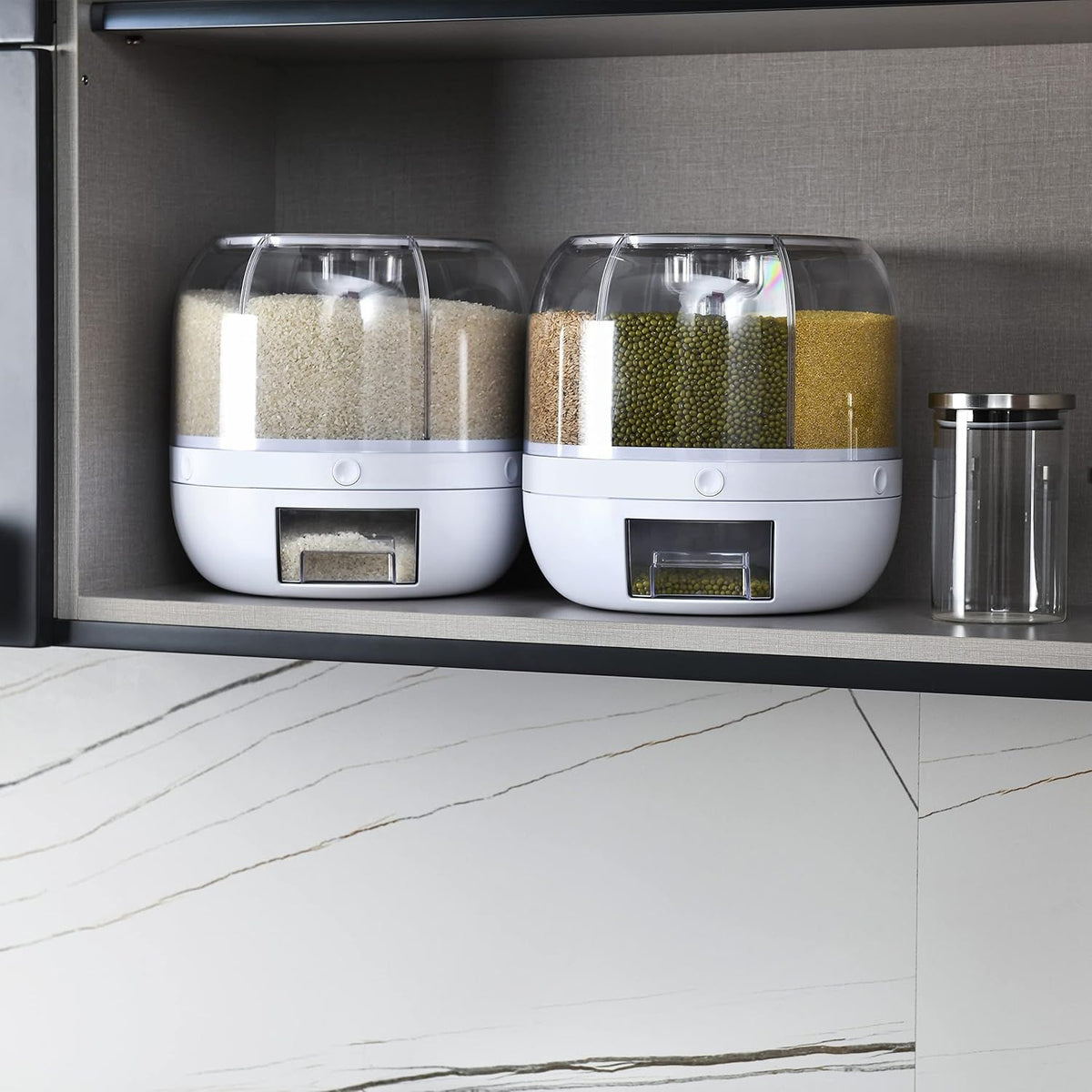 Two white kitchen storage containers with transparent lids on a shelf.