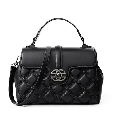 A black quilted leather handbag with a top handle, a detachable shoulder strap, and a silver-tone interlocking CC logo clasp on the front flap.