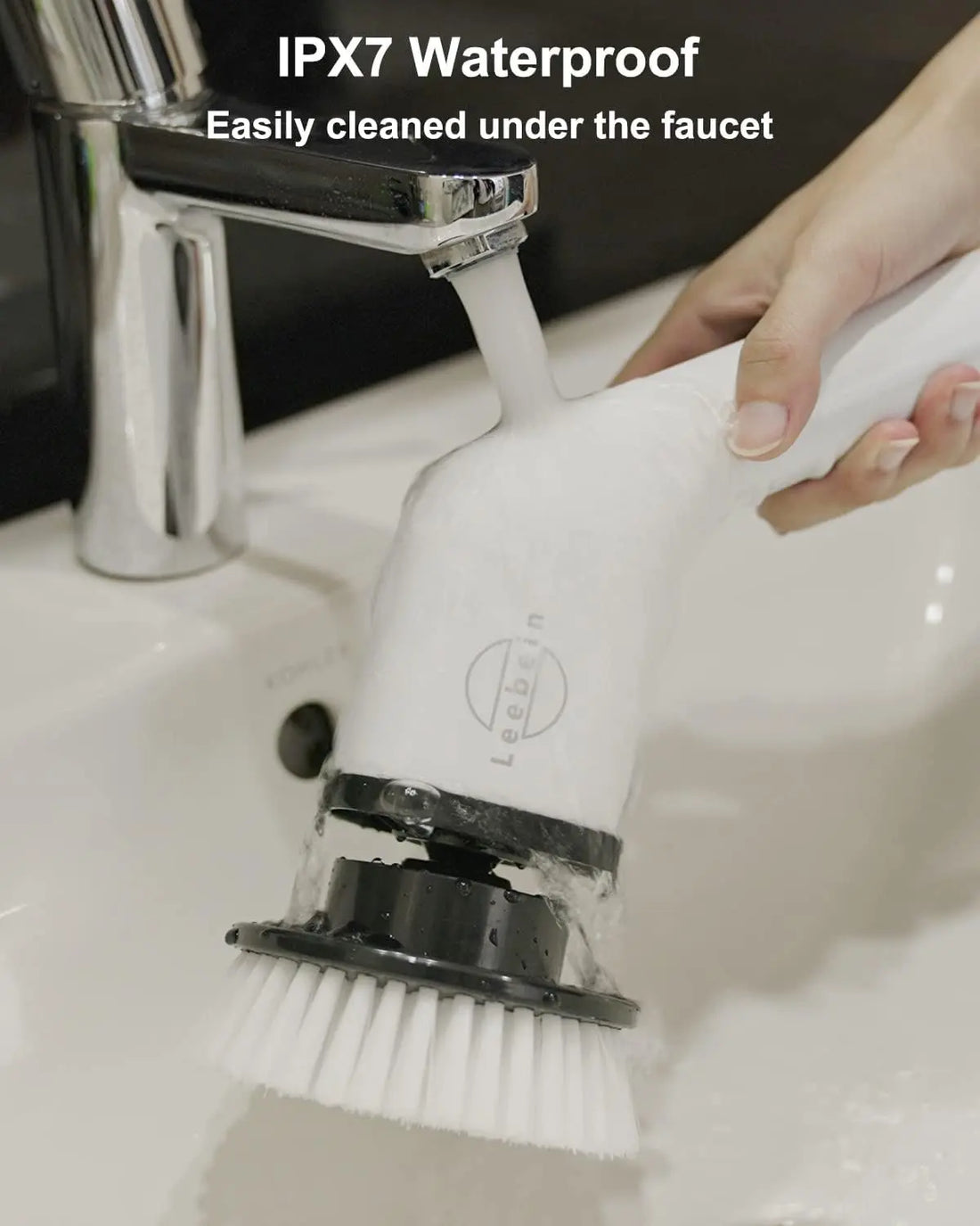 Cleaning brush with IPX7 waterproof feature being used under a faucet.