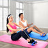 Two people exercising on pink and blue mats using resistance bands in a bright room.