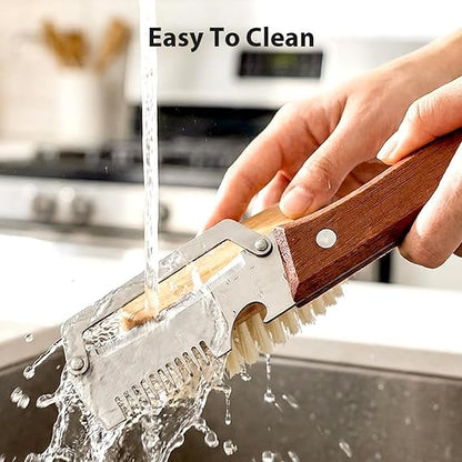 Cleaning brush with wooden handle being rinsed under running water in a kitchen setting.