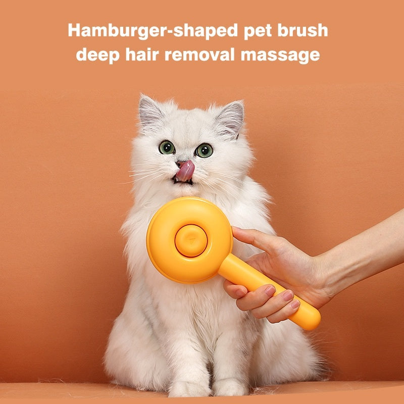 A white long-haired cat sits against a warm orange background while a person holds a bright yellow pet grooming brush in front of its face. White text at the top reads, &