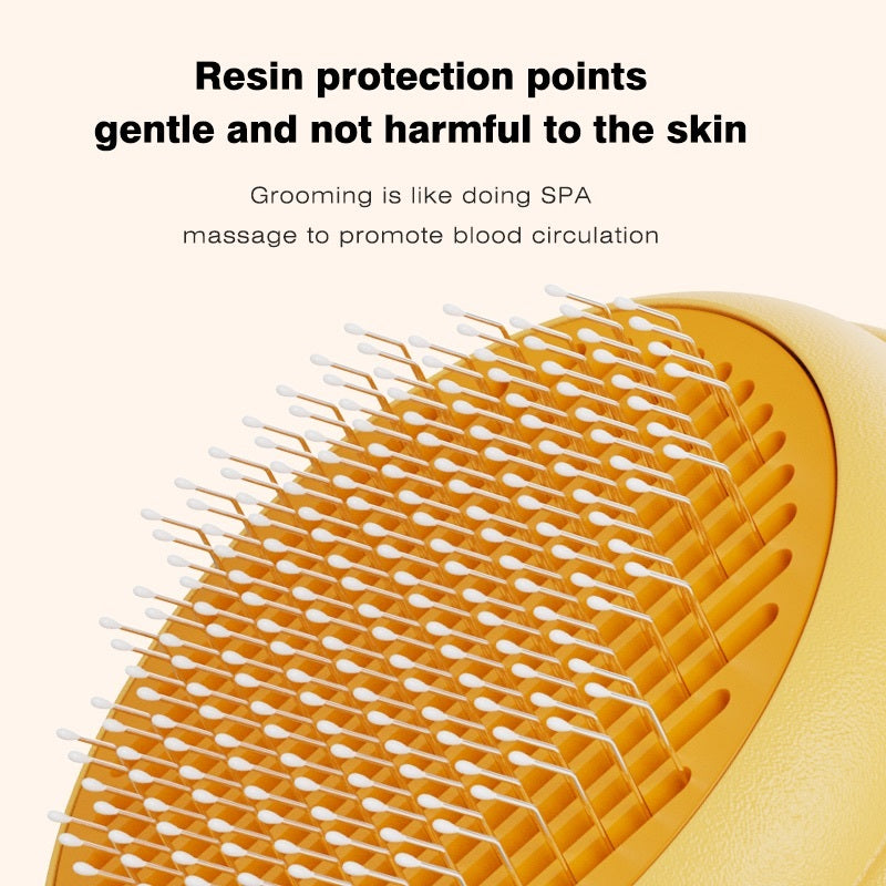 Close-up of a yellow and orange pet grooming brush with white bristles, shown with promotional text about gentle resin protection points and spa-like grooming massage.