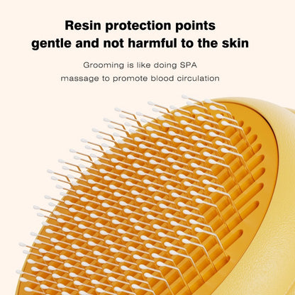 Close-up of a yellow and orange pet grooming brush with white bristles, shown with promotional text about gentle resin protection points and spa-like grooming massage.