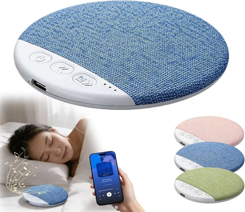 Blue fabric pillow with control panel, person using phone, and additional pillows in the background.