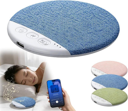 Blue fabric pillow with control panel, person using phone, and additional pillows in the background.