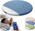 Blue fabric pillow with control panel, person using phone, and additional pillows in the background.