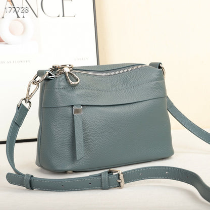 Green handbag with a strap on a light background