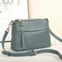 Green handbag with a strap on a light background