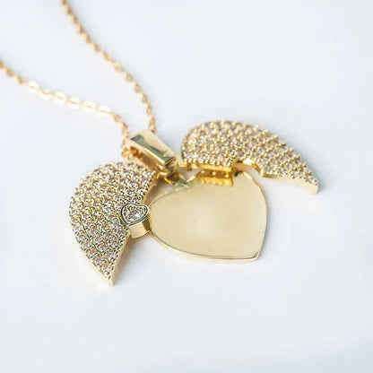 Gold necklace with heart-shaped pendants on a light gray background