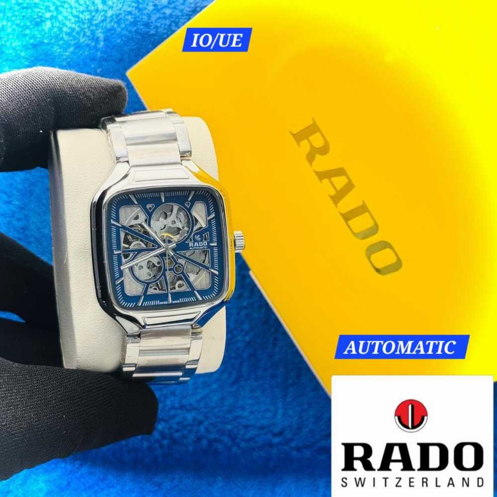 Silver Rado watch with a blue face on a blue and yellow background