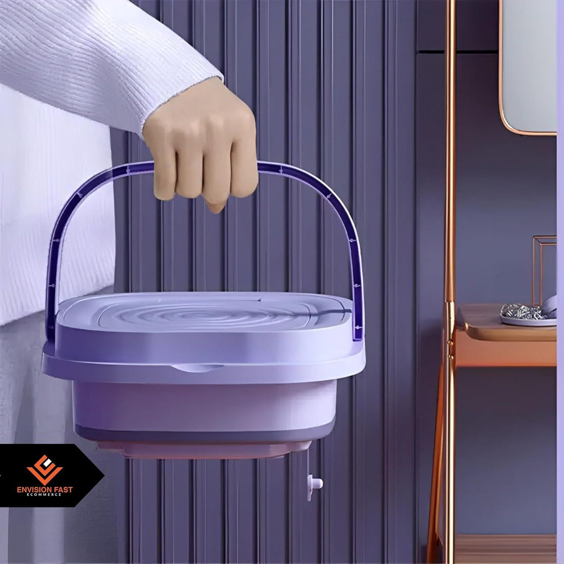 Purple and white collapsible bucket held by a hand against a neutral background
