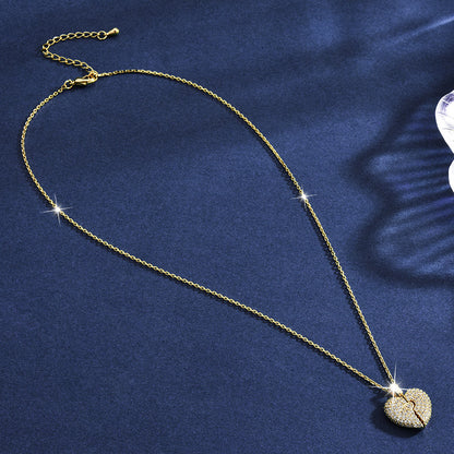 Gold necklace with a heart-shaped pendant on a blue fabric background